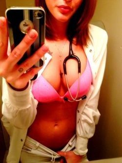 Showing off her bra and her stethoscope.