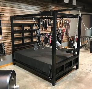 Sex dungeon bed with sling