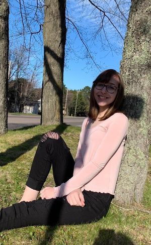 adorable tight teen sitting by a tree