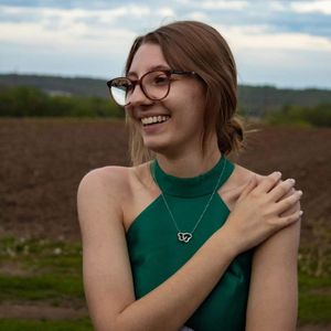super cute teen with glasses outside in a dress