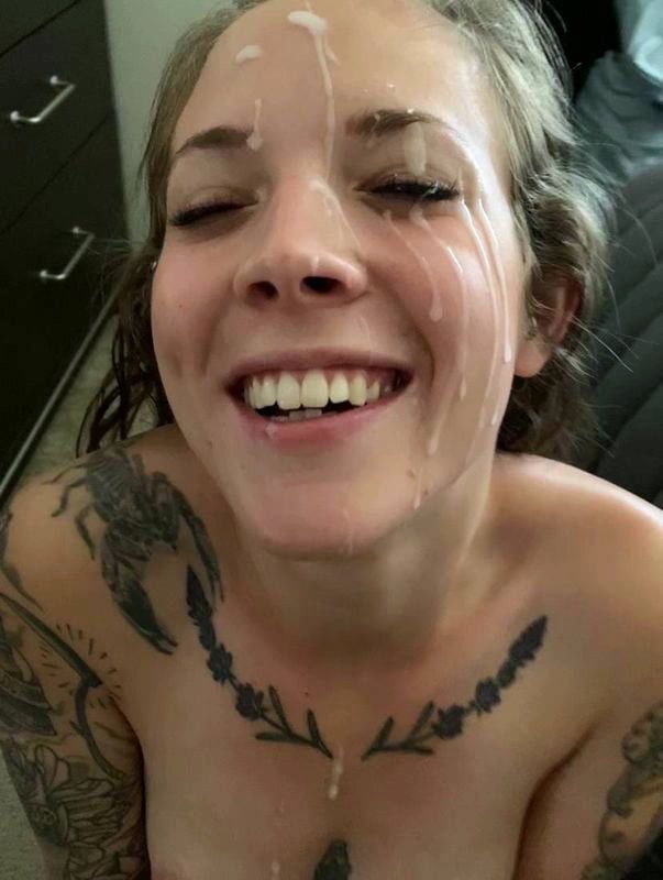 Beautiful babe giggling with cum all over her face