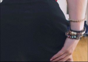 Pulling her skirt up