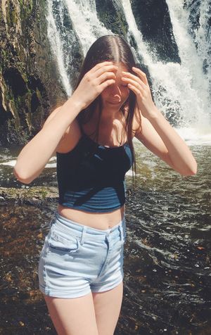 thin teen at waterfall