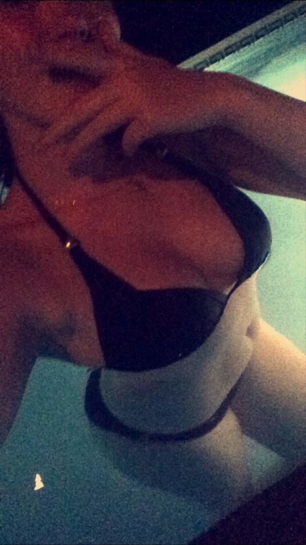 Sexy brunette slut taking selfies in pool