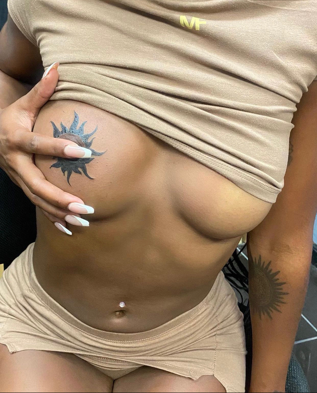 Tattoo on her breast
