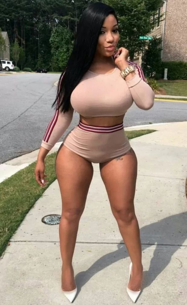 Busty ebony with big fake tits in public