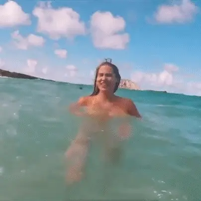 Busty babe adjusting her huge tits in her bikini