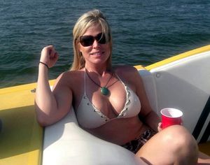Teenage son takes a picture of his mother on the family boat!