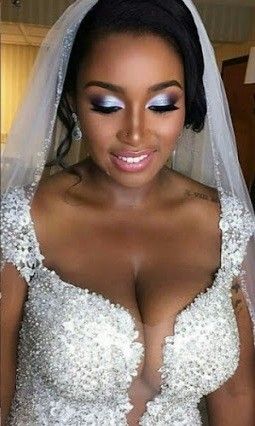 Ebony bride displays her cleavage