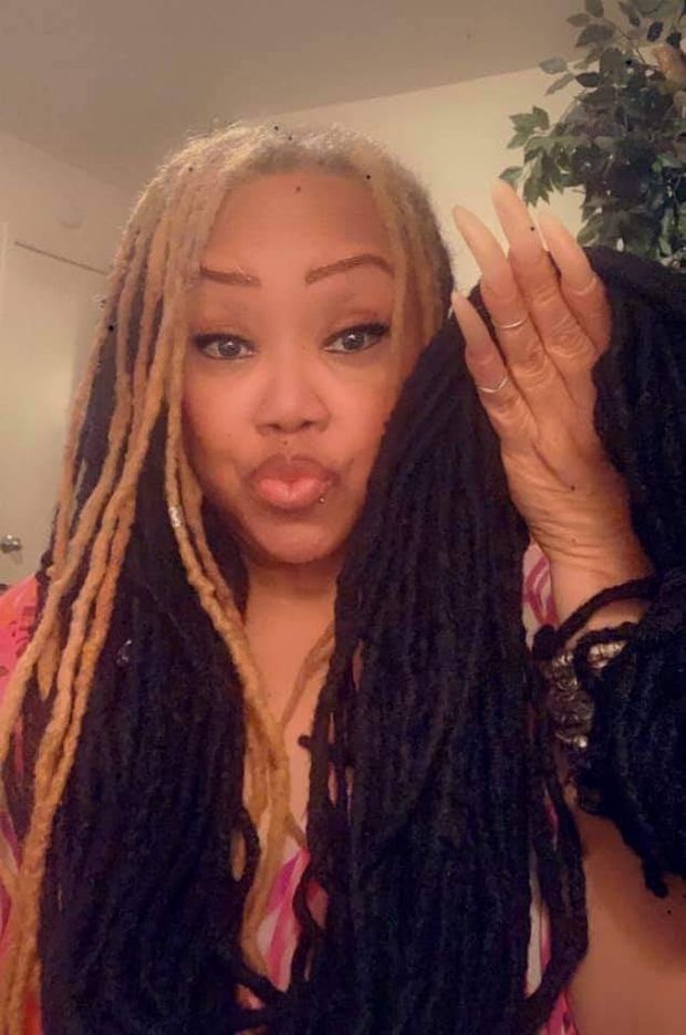 Holding her locs.