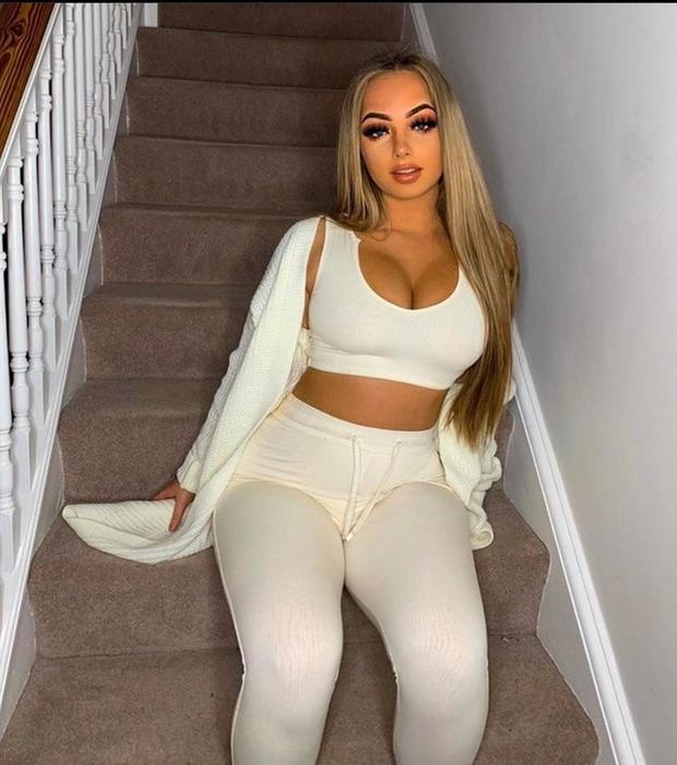 Hot Busty Blonde Sitting On the Stairs