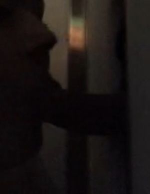 In a dark arcade booth, sucking off a stranger through a gloryhole