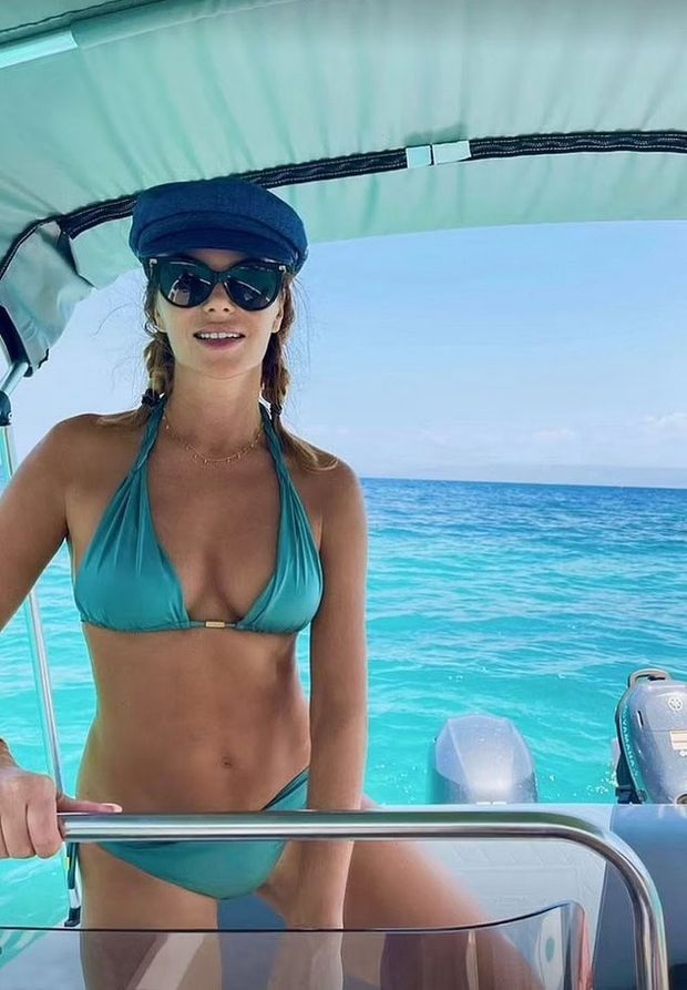 Blonde beauty in aqua on a boat.