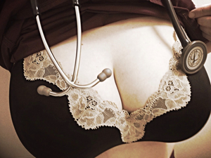 Nurse showing off her Beautiful Cleavage in a bra