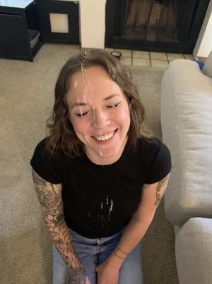 Cute tattooed brunette covered in cum