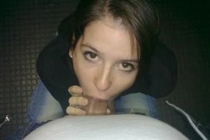 Cute brunette looking up and sucking on cock