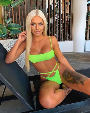 Blonde with intense eyes in neon green bikini