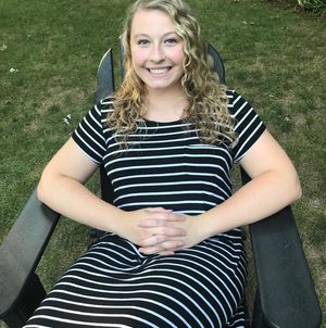 cute blonde sitting outdoors