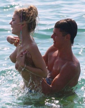 Woman's top comes off while swimming