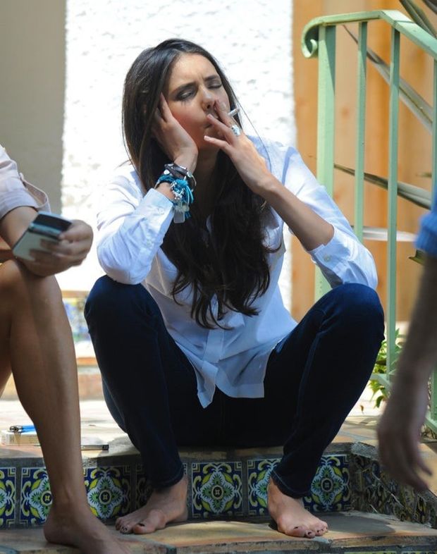 Nina Dobrev taking a quick break from shooting