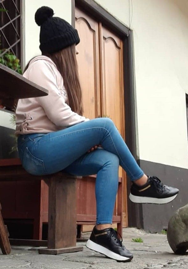 crossed legs in blue jeans