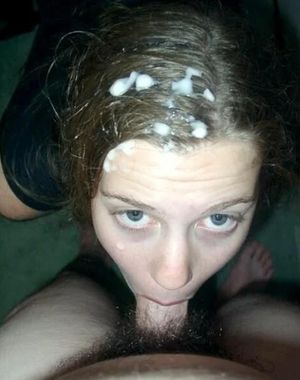 Brunette covered in cum, but still sucking