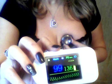 Busty woman uses heart monitor