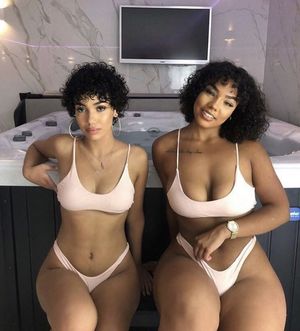 Two beautiful ebony curly haired queens