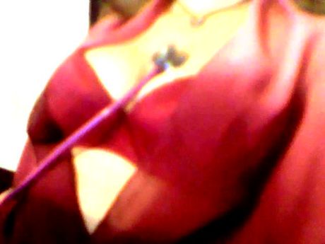 Woman in Red bra listening to her heartbeat with a stethoscope.