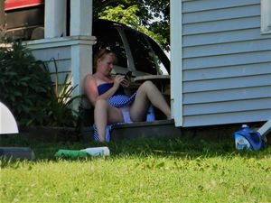 Redhead cooling off her lips