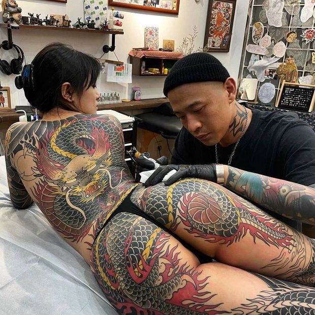 Beautiful asian with a legendary tattoo