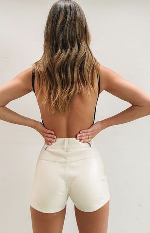 Nice rear view of a hottie in her leather booty-shorts