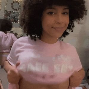 Cute black chick showing little tits