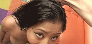 Asian slut swallowing a big white man's cock