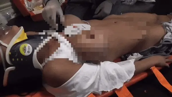 Paramedic checking naked chick for heartbeat