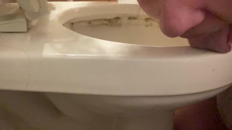 My filthy slave cleaning her friend's dirty toilet with her tongue