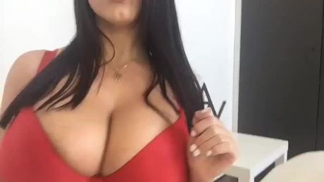 Angela White showing off her cleavage in a Red bra.