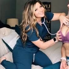 Cute nurse listening to her patient’s heartbeat with a stethoscope