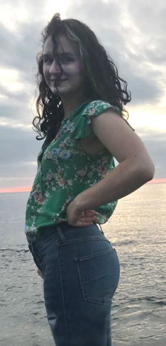 posing by the sea