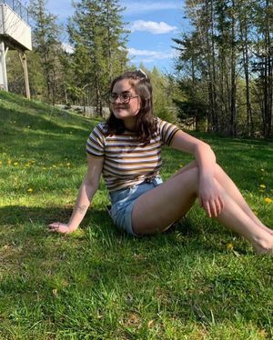 cute teen sitting on the grass