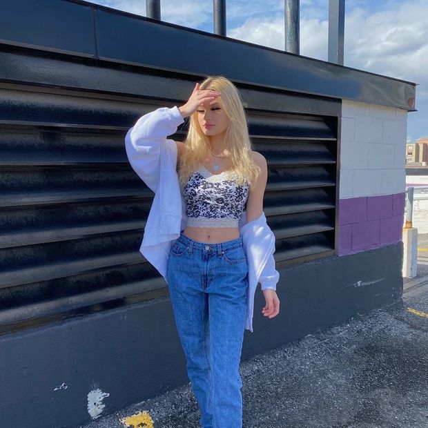 Lily in jeans hand sun shield