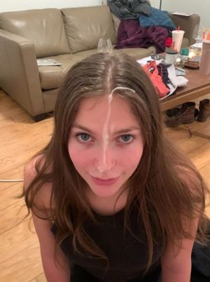 Very pretty brunette with a long strand of cum on her face