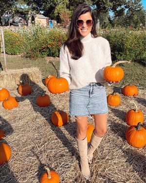 Sexy woman in a denim mini-skirt and boots