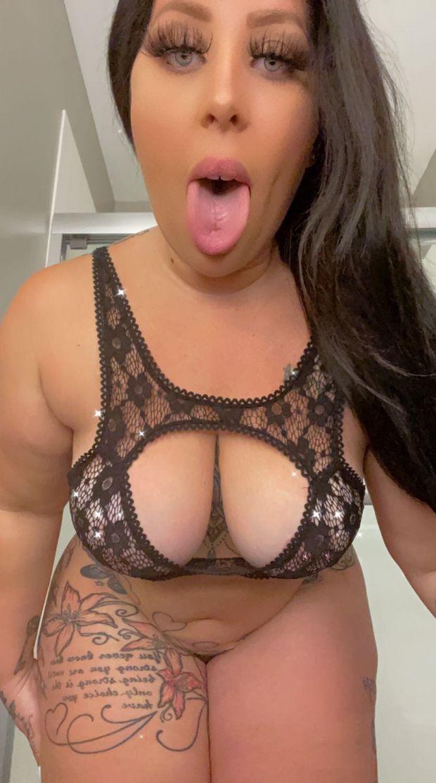 Thunda sticking tongue out in black lingerie