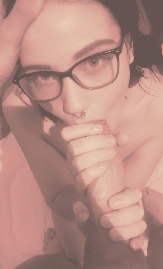 Brunette with nose piercing and glasses sucking cock