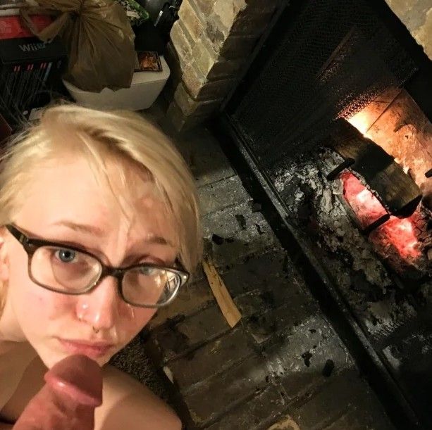 Cute blond with glasses taking a facial next to a fireplace