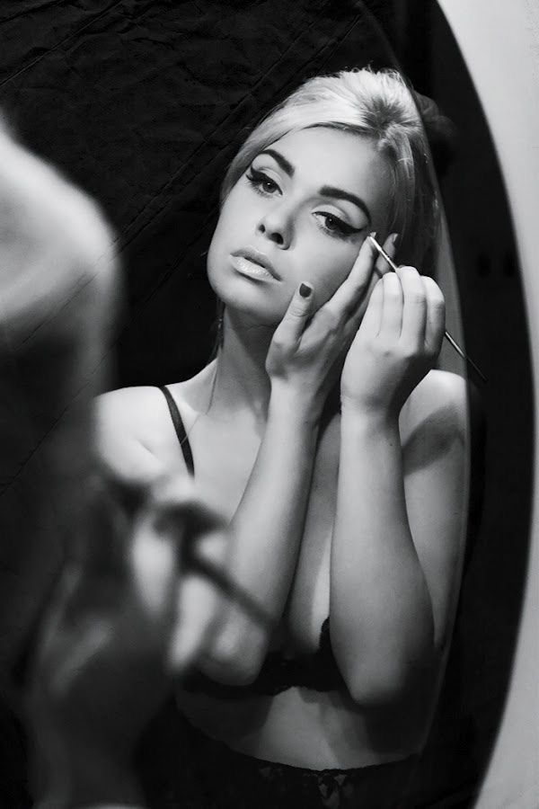Adorable women applying eye-makeup