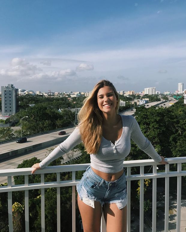 Kat Jimenez - smiling in jean shorts