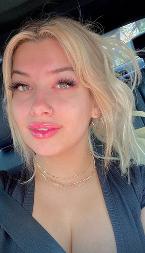 Blonde milf selfshot showing her cleavage with awesome mouth and lipstick . Do you like her big natural tits ?