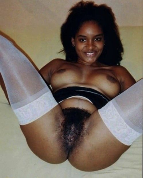 Spreading her legs showing hairy pussy
